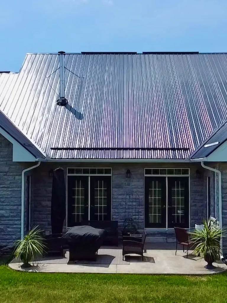 Finished bunkie with covered porch and metal roof by N.S. Custom Contracting in Ontario