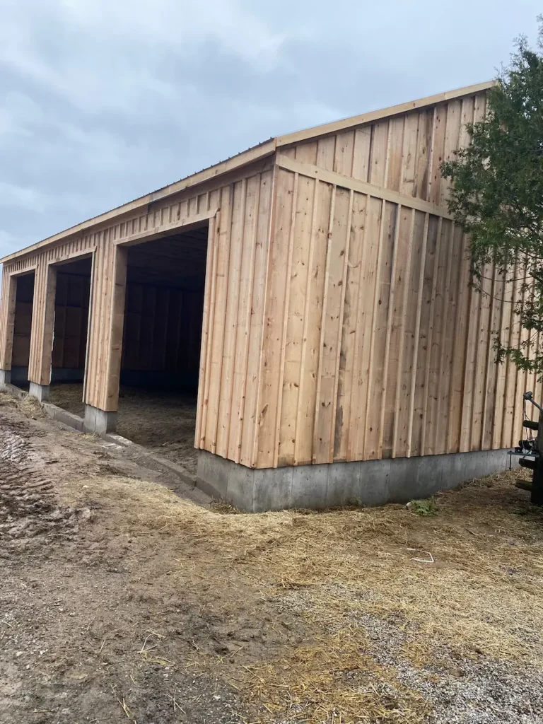 Completed 3-bay detached garage on a Caledon farm with spruce board and batten siding'