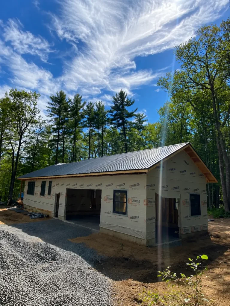 Exterior view of a finished backyard workshop with sliding barn door in Ontario