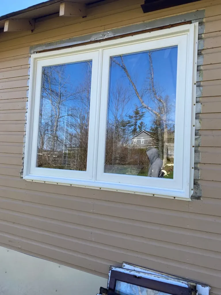 looking up at window from below, showing trim detail against sky]