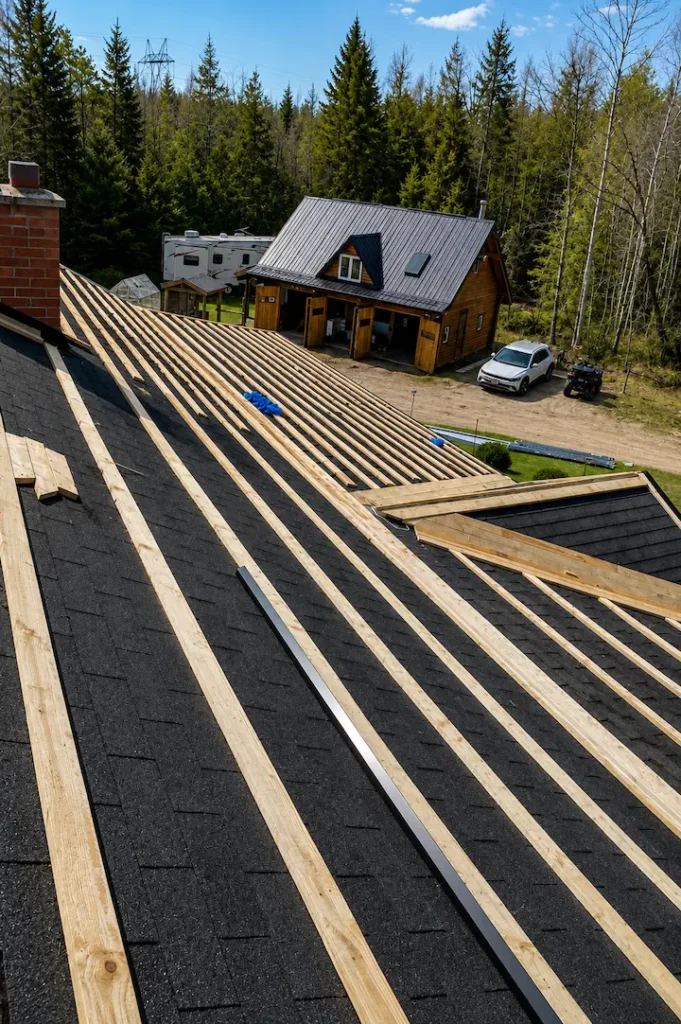 Original asphalt shingles exposed on Pontypool home after solar panel removal before steel re-cover