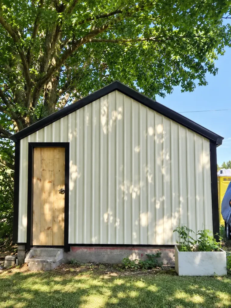 finished gable end, tan steel and black trim